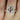 Close-up of 14kt rose gold cushion morganite diamond pave halo bridal set on hand